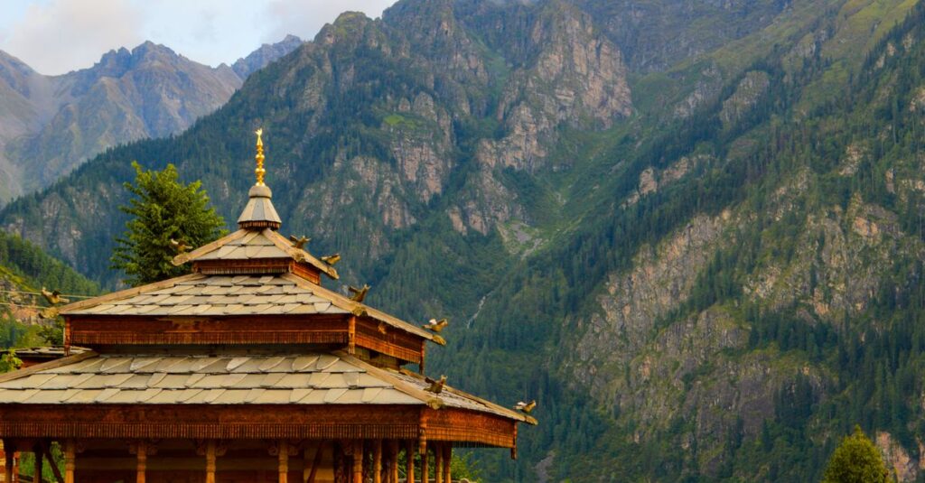 Discover a serene Himachal Pradesh temple set against stunning mountain backdrops, capturing Indian architecture.